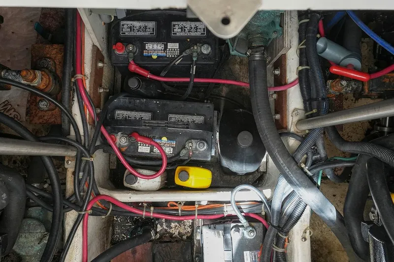 Slide: The Image of Engine compartment of a 2000 Carver 350 Mariner with visible batteries and wiring. - 41