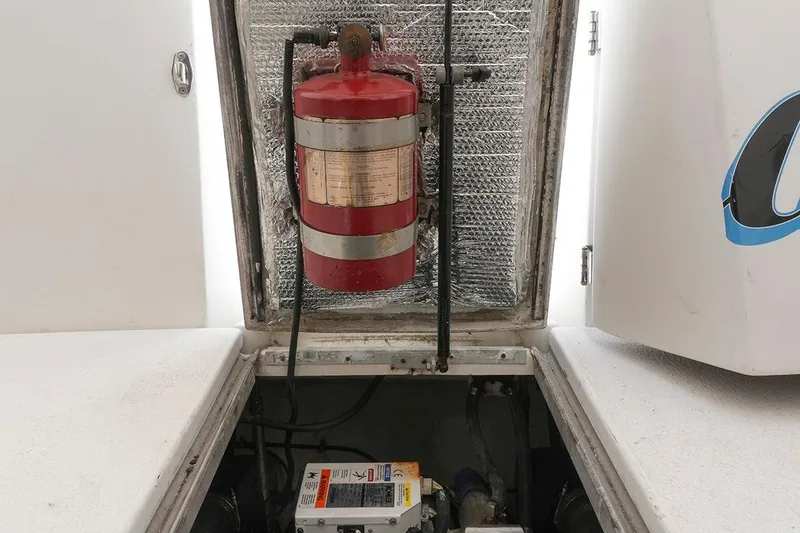 Slide: The Image of Engine compartment of 2000 Carver 350 Mariner with fire extinguisher and equipment. - 42