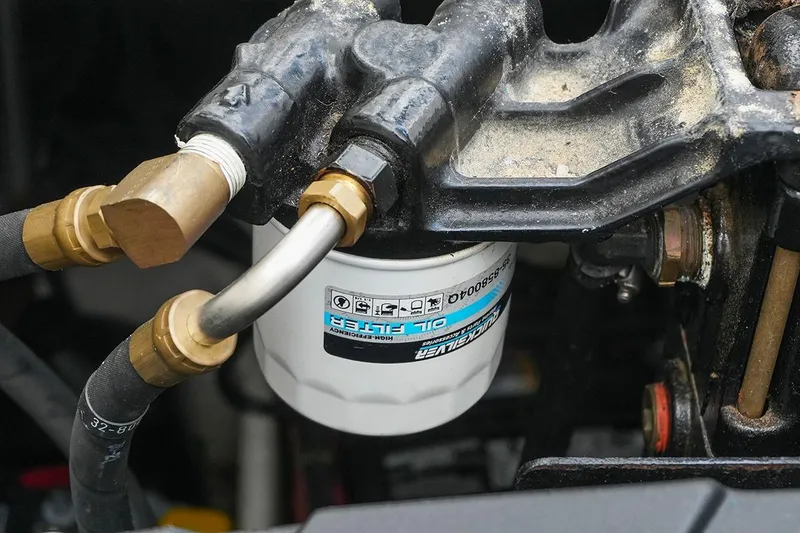 Slide: The Image of Oil filter and hoses in a 2000 Carver 350 Mariner engine compartment. - 45