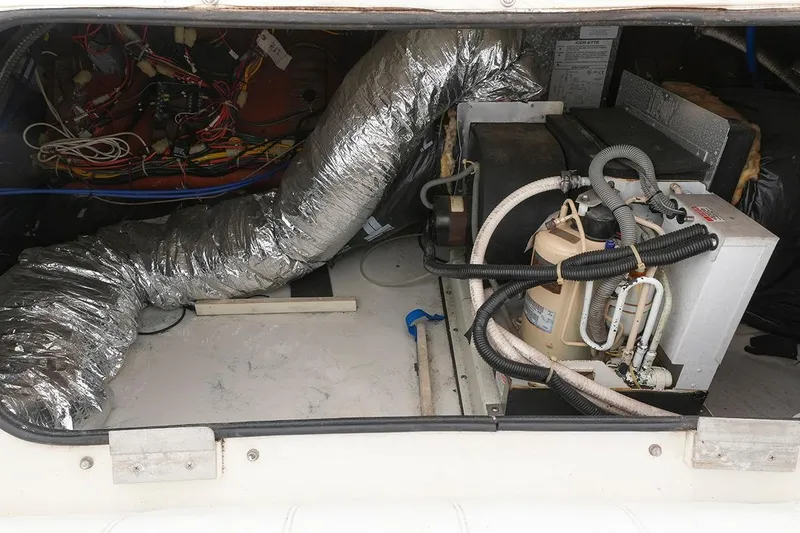 Slide: The Image of Engine compartment of a 2000 Carver 350 Mariner with visible wiring and ductwork. - 46