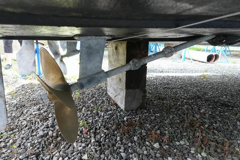 Slide: The Image of Propeller and shaft of a 2000 Carver 350 Mariner on gravel surface. - 48