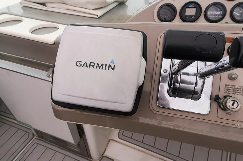 Slide: The Image of Garmin navigation system on 2000 Carver 350 Mariner boat dashboard with control levers. - 5