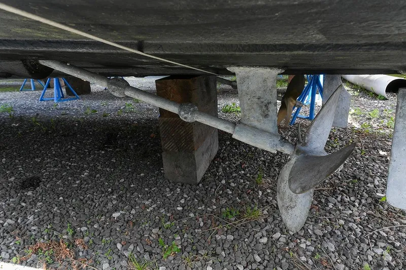 Slide: The Image of Underneath view of a 2000 Carver 350 Mariner boat showing propeller and support. - 50