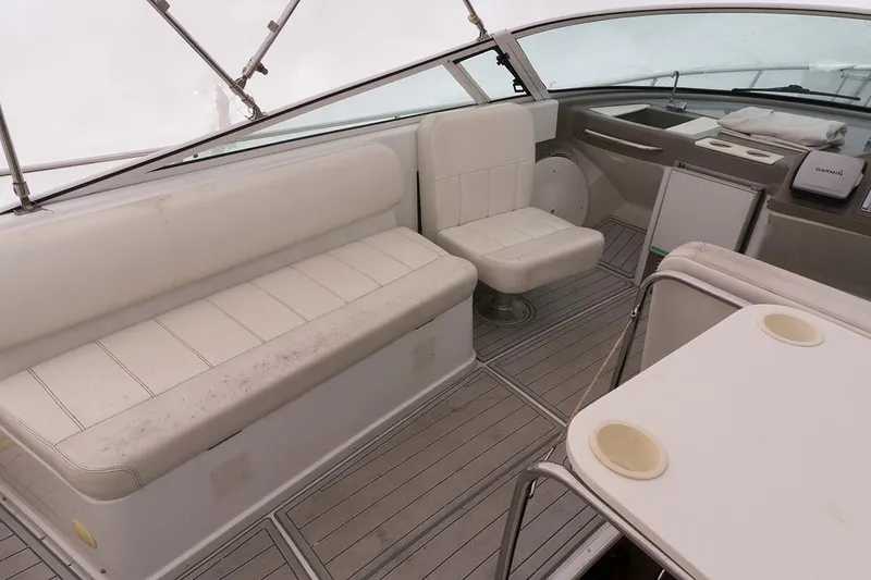 Slide: The Image of Interior of 2000 Carver 350 Mariner yacht with white seating and helm area. - 6