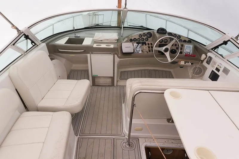 Slide: The Image of Cockpit of 2000 Carver 350 Mariner with white seating and modern controls. - 8