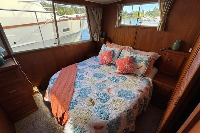 Slide: The Image of Cozy bedroom in 1984 Uniflite YACHTHOME with nautical-themed bedding and marina view. - 11