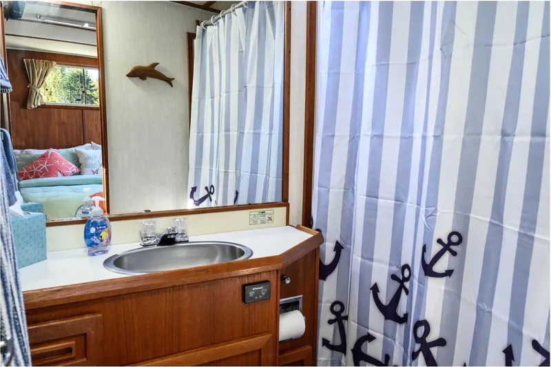 Slide: The Image of 1984 Uniflite YACHTHOME bathroom with nautical-themed decor and wooden cabinetry. - 12
