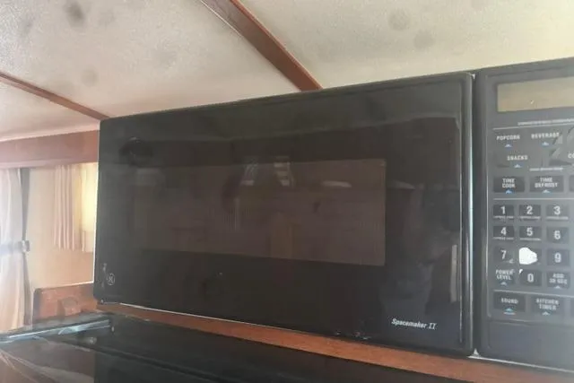 Slide: The Image of Microwave oven inside a 1984 Uniflite YACHTHOME, featuring a Spacemaker II model. - 19