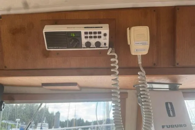 Slide: The Image of 1984 Uniflite YACHTHOME interior with marine radio and microphone setup. - 23