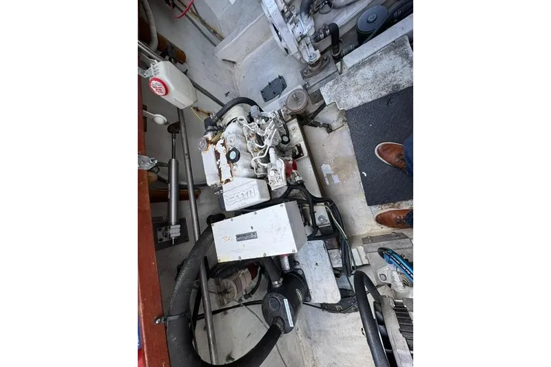 Slide: The Image of Engine compartment of a 1984 Uniflite YACHTHOME, showcasing mechanical components and wiring. - 31