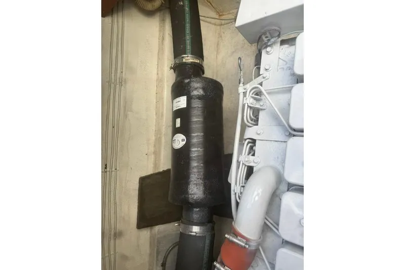 Slide: The Image of Engine compartment of 1984 Uniflite YACHTHOME, featuring exhaust system and piping. - 33