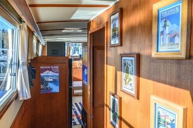 Slide: The Image of Interior hallway of 1984 Uniflite YACHTHOME with framed artwork and wooden paneling. - 9