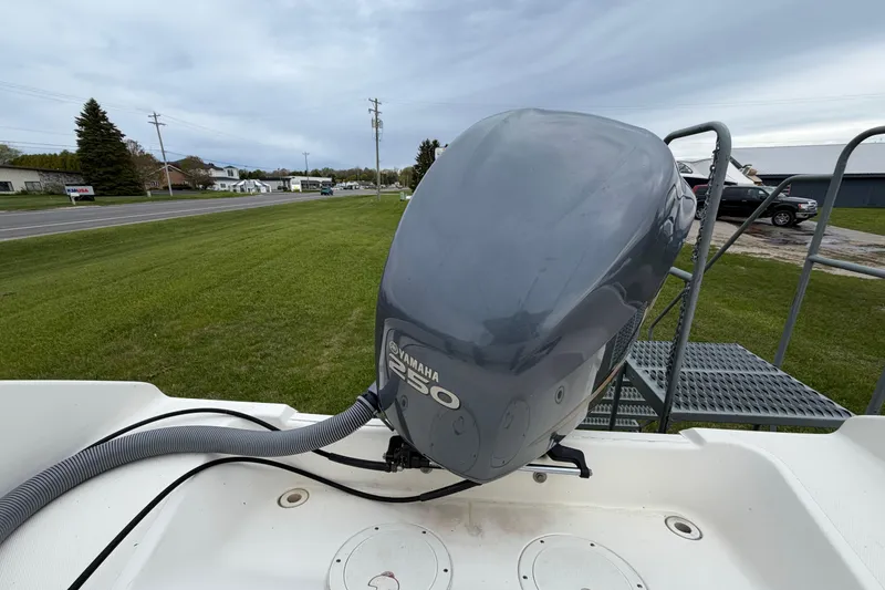 Slide: The Image of 2006 Pursuit 2570 Offshore boat with Yamaha 250 outboard motor on grassy area. - 10