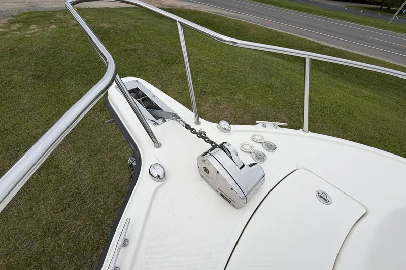 Slide: The Image of 2006 Pursuit 2570 Offshore boat deck with anchor winch and railing. - 11