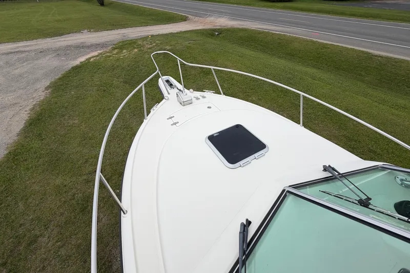 Slide: The Image of 2006 Pursuit 2570 Offshore boat on grassy area near road. - 12