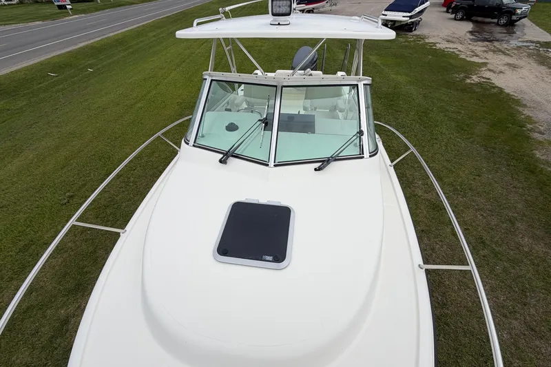 Slide: The Image of 2006 Pursuit 2570 Offshore boat, aerial view, parked on grass near road. - 13