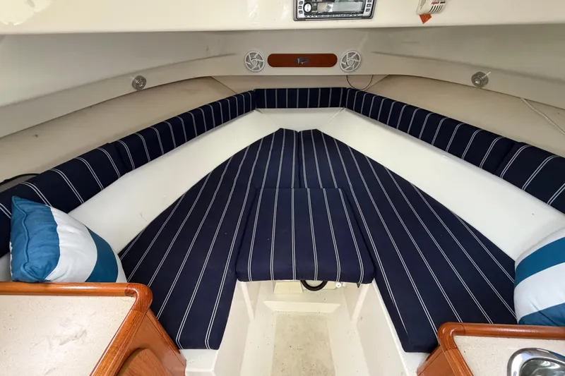 Slide: The Image of Interior cabin of 2006 Pursuit 2570 Offshore boat with striped cushions and pillows. - 30