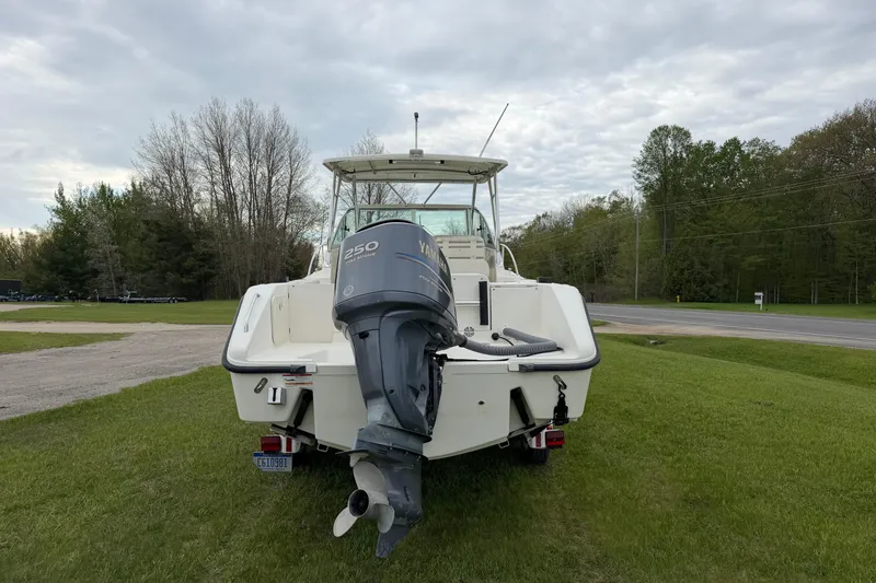 Slide: The Image of 2006 Pursuit 2570 Offshore boat with Yamaha 250 engine, parked on grass. - 8