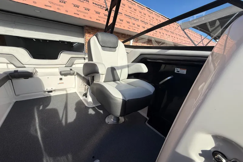 Slide: The Image of Interior of a 2020 Yamaha AR230 boat featuring a comfortable captain's chair. - 13