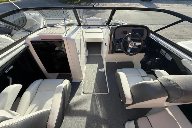 Slide: The Image of 2020 Yamaha Boats AR230 interior with modern seating and sleek steering console. - 15
