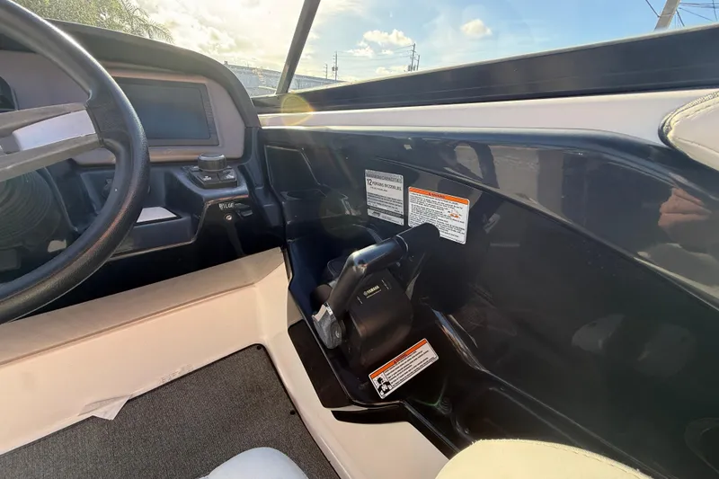 Slide: The Image of Interior view of 2020 Yamaha Boats AR230 cockpit with steering wheel and controls. - 18