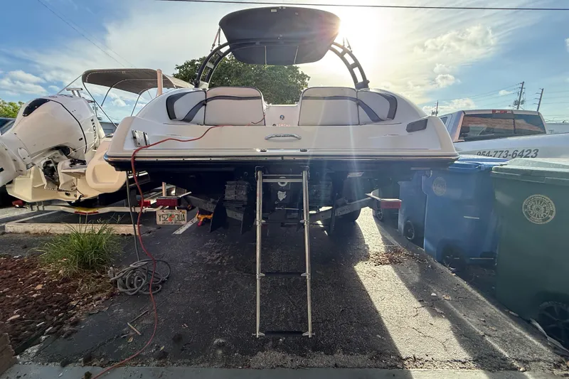 Slide: The Image of 2020 Yamaha Boats AR230 on trailer, rear view with ladder extended, sunny day. - 4
