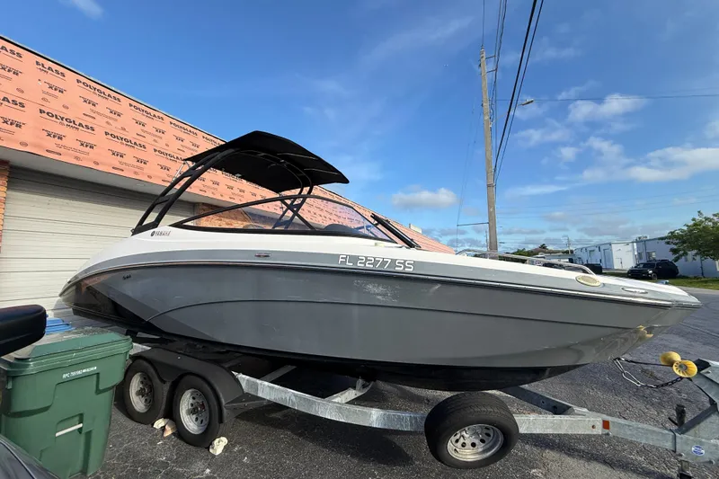 Slide: The Image of 2020 Yamaha Boats AR230 on trailer, parked outdoors under clear sky. - 7