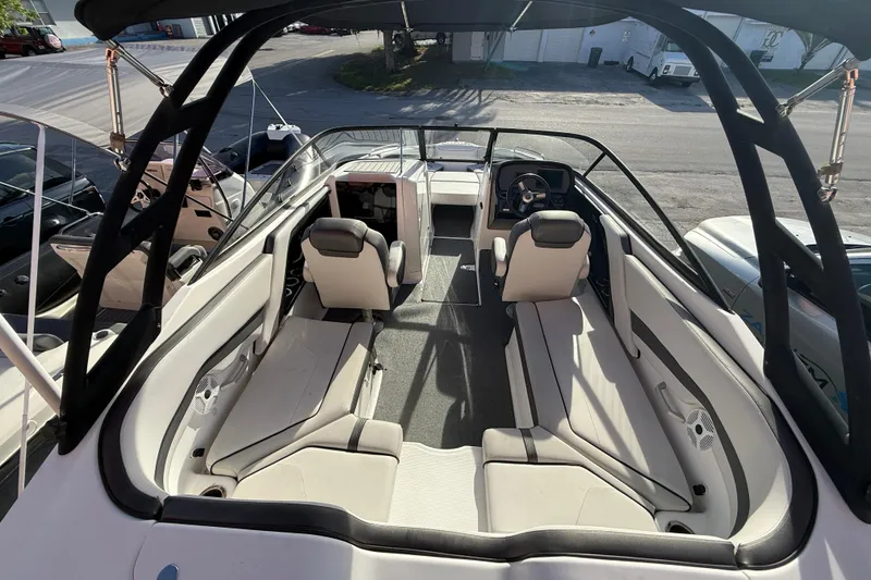 Slide: The Image of 2020 Yamaha Boats AR230 interior with spacious seating and modern helm design. - 8
