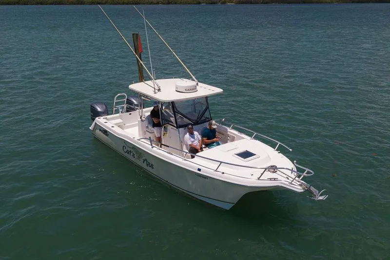 Slide: The Image of 2007 ProKat 2860 Center Console boat on water with passengers, fishing rods visible. - 11