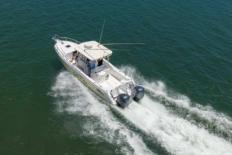 Slide: The Image of 2007 ProKat 2860 Center Console boat cruising on open water. - 12