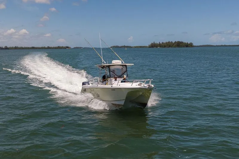 Slide: The Image of 2007 ProKat 2860 Center Console boat cruising on open water under clear skies. - 14