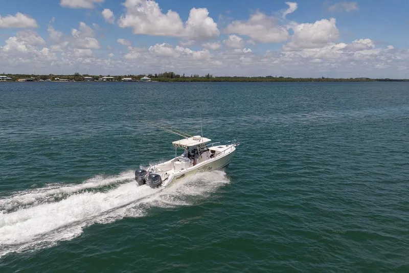 Slide: The Image of 2007 ProKat 2860 Center Console boat cruising on open water under a partly cloudy sky. - 16
