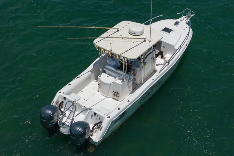 Slide: The Image of 2007 ProKat 2860 Center Console boat on water, featuring dual engines and spacious deck. - 27