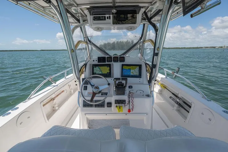 Slide: The Image of 2007 ProKat 2860 Center Console boat interior with navigation equipment on open water. - 29