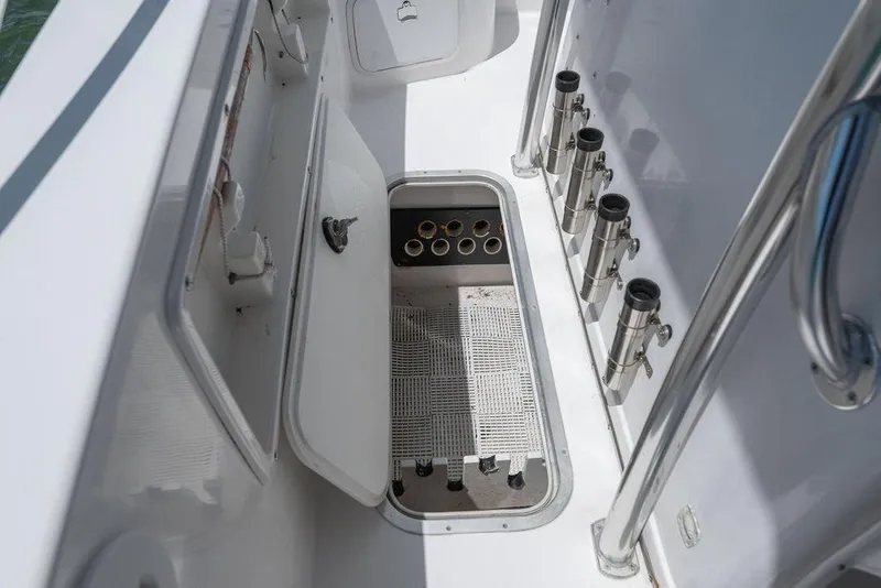 Slide: The Image of 2007 ProKat 2860 Center Console boat with open storage compartment and rod holders. - 32