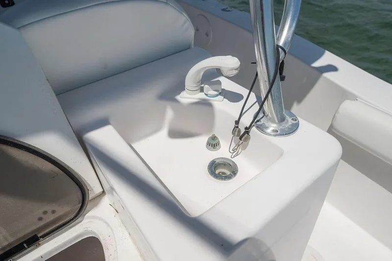 Slide: The Image of 2007 ProKat 2860 Center Console boat sink with faucet and storage area. - 37