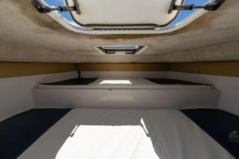 Slide: The Image of Interior cabin of 2007 ProKat 2860 Center Console boat, featuring a sunroof and cushioned seating. - 47