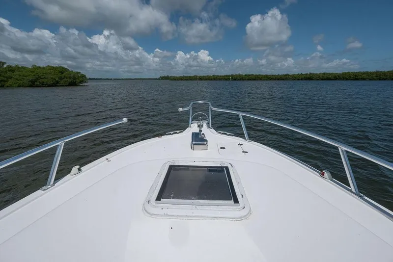 Slide: The Image of Bow view of 2007 ProKat 2860 Center Console on calm waters under blue sky. - 49