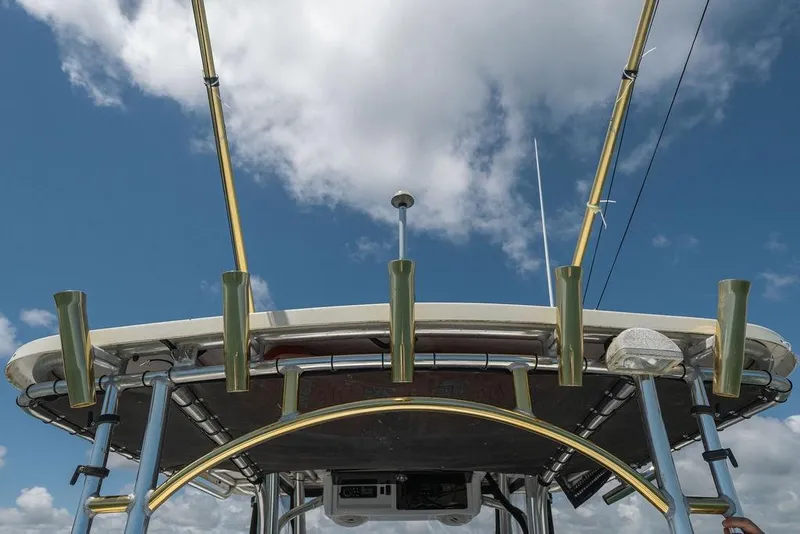 Slide: The Image of 2007 ProKat 2860 Center Console boat with fishing rod holders against a blue sky. - 50