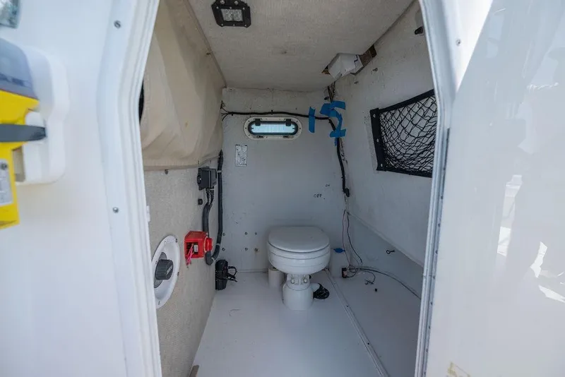 Slide: The Image of 2007 ProKat 2860 Center Console boat interior with toilet and storage features. - 53