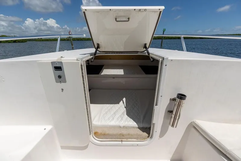 Slide: The Image of 2007 ProKat 2860 Center Console boat cabin with open hatch, overlooking serene water. - 59