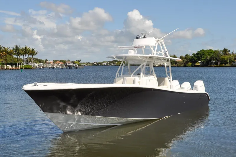 Slide: The Image of 2011 Yellowfin 39 Offshore boat cruising on a calm, scenic waterway. - 1