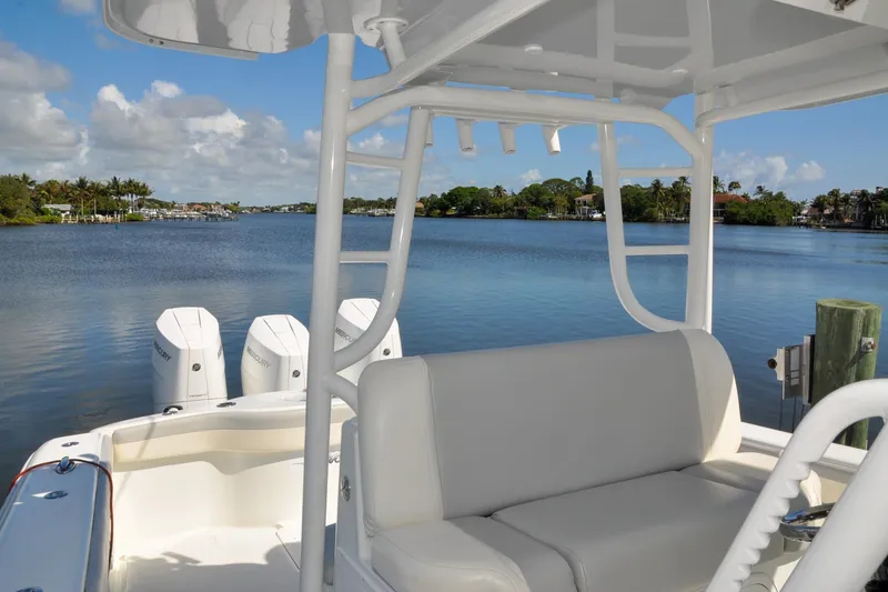 Slide: The Image of 2011 Yellowfin 39 Offshore boat with triple Mercury engines on a serene waterway. - 11