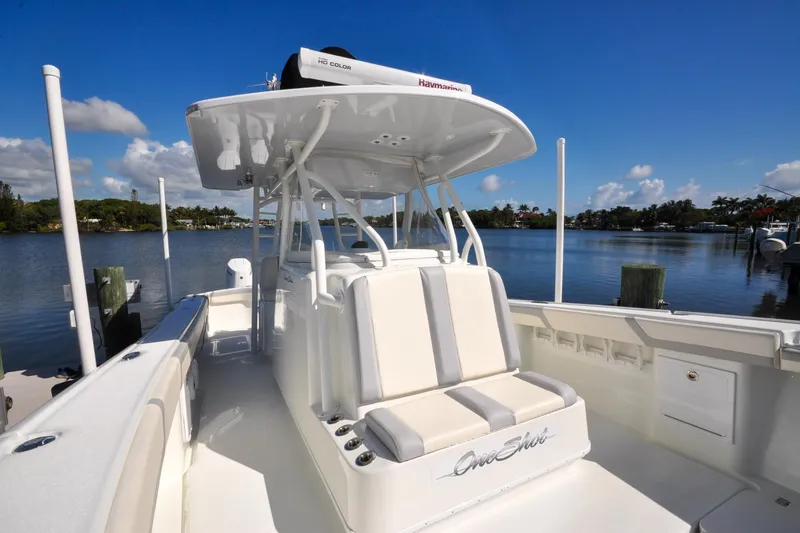 Slide: The Image of 2011 Yellowfin 39 Offshore boat docked on a sunny day, showcasing sleek design and spacious seating. - 12