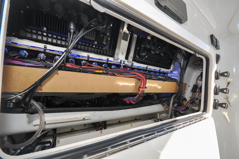 Slide: The Image of Electrical wiring inside a 2011 Yellowfin 39 Offshore boat, showcasing organized cables and components. - 15