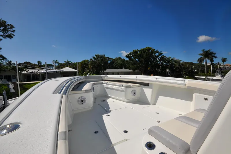 Slide: The Image of 2011 Yellowfin 39 Offshore boat deck with seating, under clear blue sky. - 19
