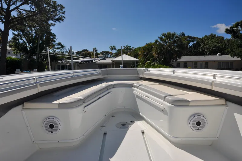 Slide: The Image of 2011 Yellowfin 39 Offshore boat interior with cushioned seating and speakers. - 28