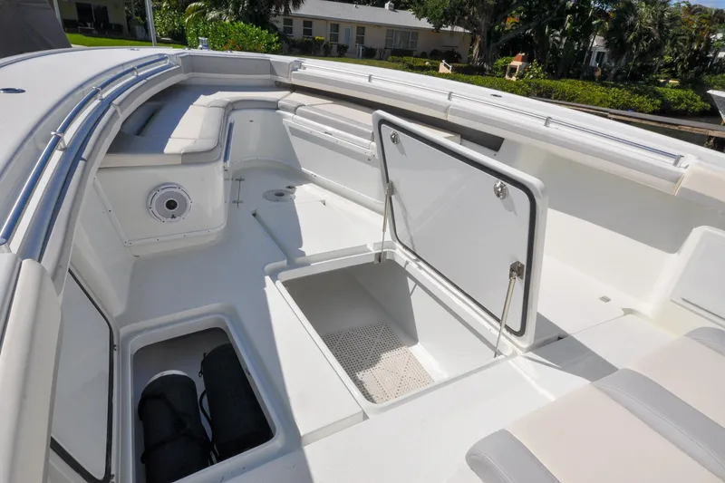Slide: The Image of 2011 Yellowfin 39 Offshore boat interior with open storage compartments and seating. - 29