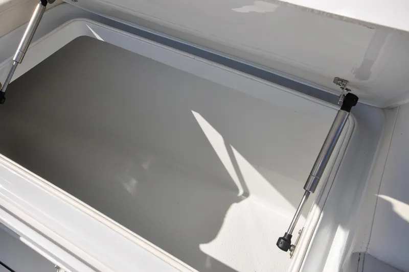 Slide: The Image of Open storage compartment on 2011 Yellowfin 39 Offshore boat, featuring hydraulic struts. - 31