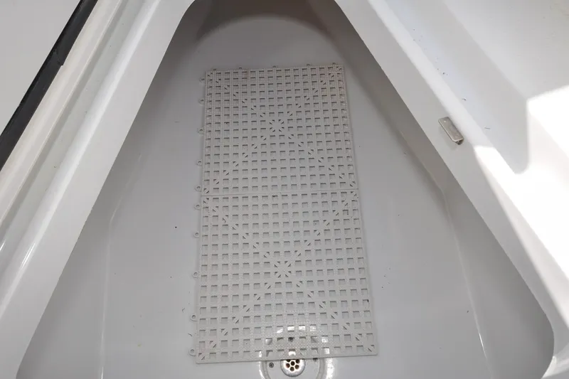 Slide: The Image of Storage compartment of a 2011 Yellowfin 39 Offshore boat with a drainage grate. - 32
